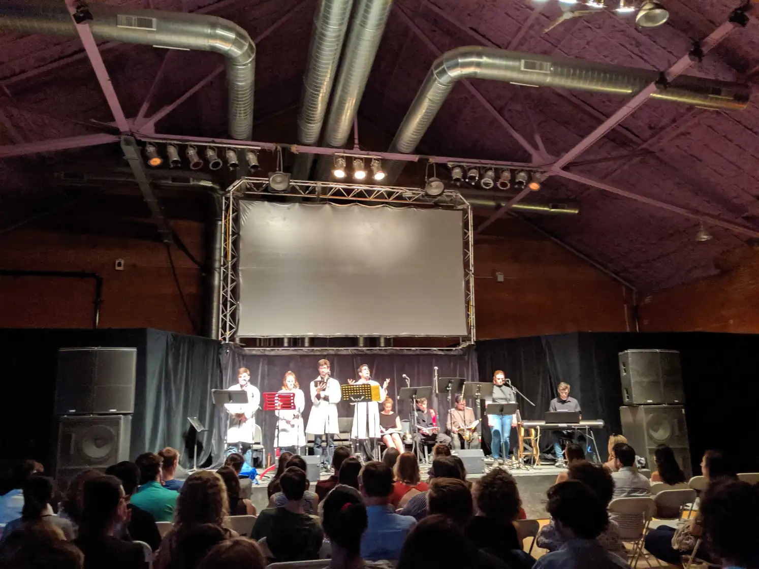 The Haber staged reading in performance — cast in lab coats at music stands before a full house